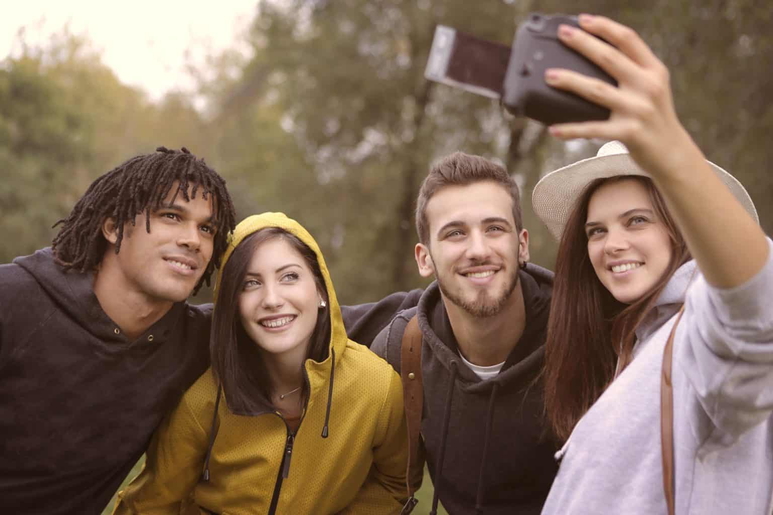 happy-diverse-friends-taking-selfie-in-park-3776813